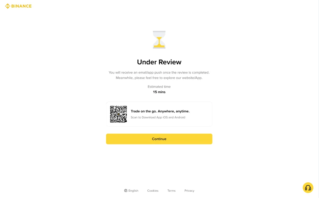 币安网页「Under Review」页面截图：沙漏图标，提示提交的资料正在审核、完成后会收到邮件或 App 通知，Estimated time 显示 15 mins，下方有下载 App 的二维码和黄色 Continue 按钮
